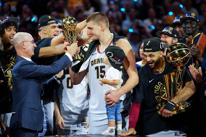 NBA commissioner Adam Silver awards Nikola Jokić with the NBA Finals MVP award.